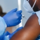 A healthcare worker administering the COVID-19 vaccine. Credit: Mongkolchon Akesin/Shutterstock