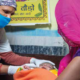 A healthcare worker attending a baby while the baby's mother is watching. Credit: UNICEF
