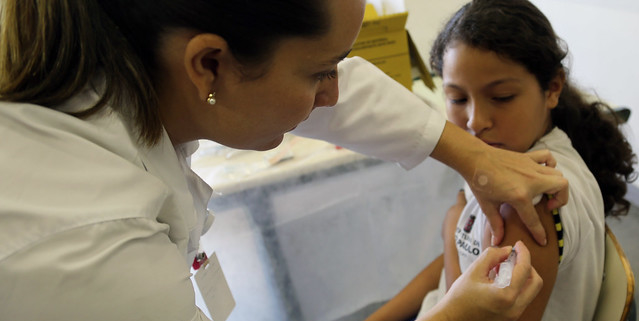 A healthcare worker administering a vaccine