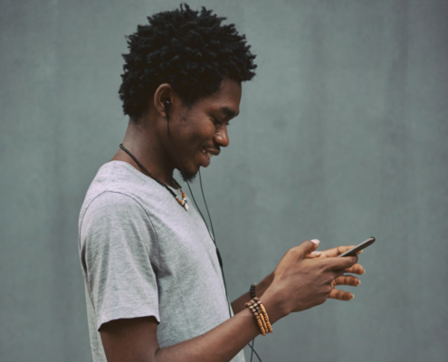 A young man using a smartphone. Source: Unsplash; Copyright: Emmanuel Ikwuegbu; License: Licensed by JMIR