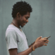 A young man using a smartphone. Source: Unsplash; Copyright: Emmanuel Ikwuegbu; License: Licensed by JMIR