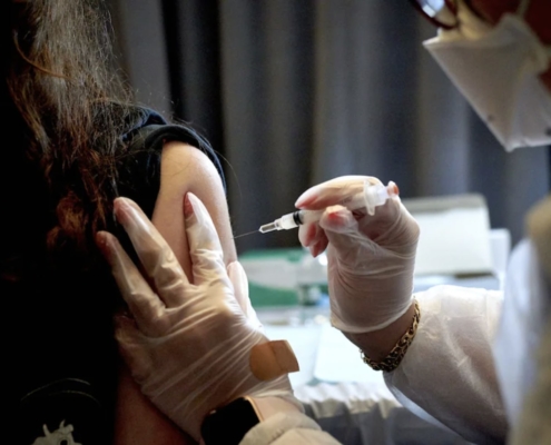 A health-care worker administers a dose of the Moderna coronavirus vaccine in New York in April. Photo Credit: Gabby Jones/Bloomberg News