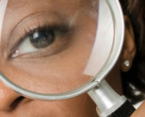 A woman holding a magnifying glass