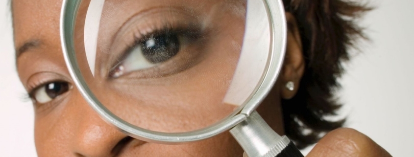 A woman holding a magnifying glass
