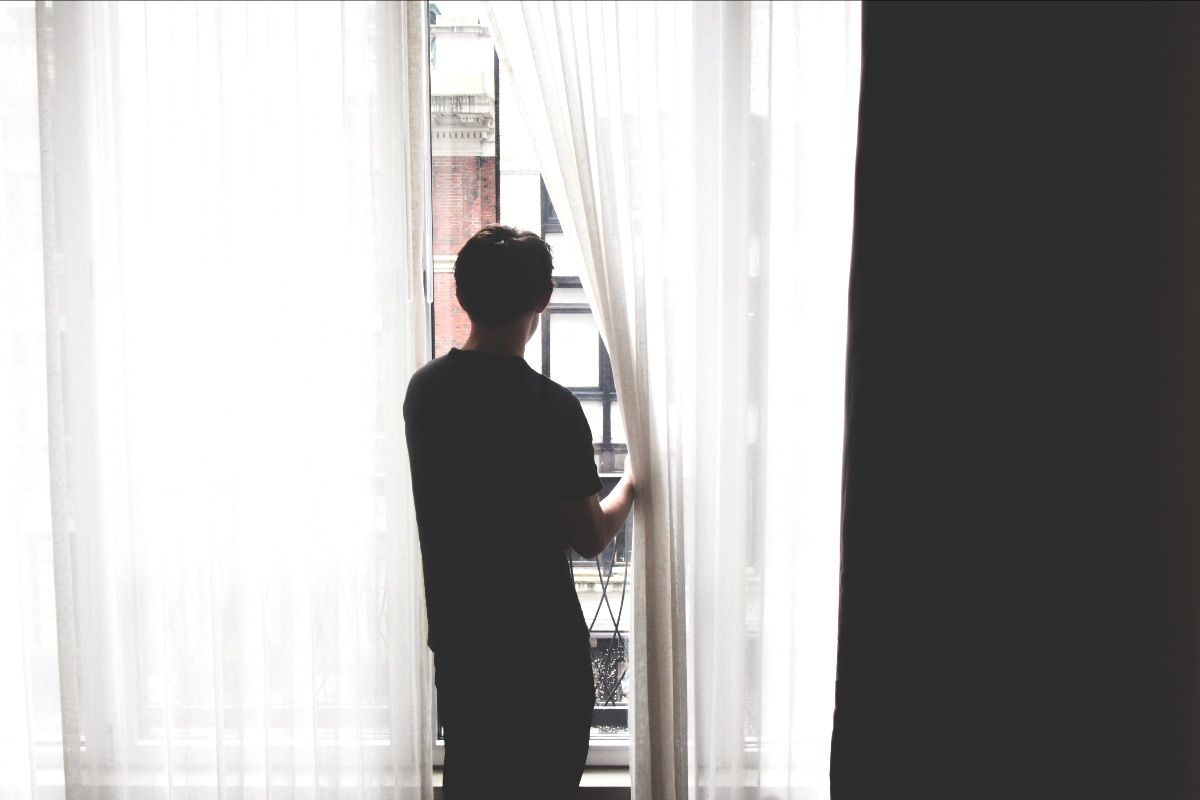 A man looking outside a window