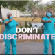 Two nurses dancing with the words "Don't Discriminate" on the screen