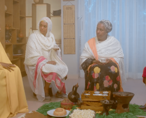Four Ethiopian people sitting together drinking tea