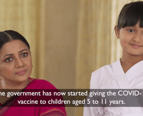 A woman and her daughter from Bangladesh listening to someone off-screen. The text reads: "The government [of Bangladesh] has now started giving the COVID-19 vaccine to children aged 5 to 11 years."