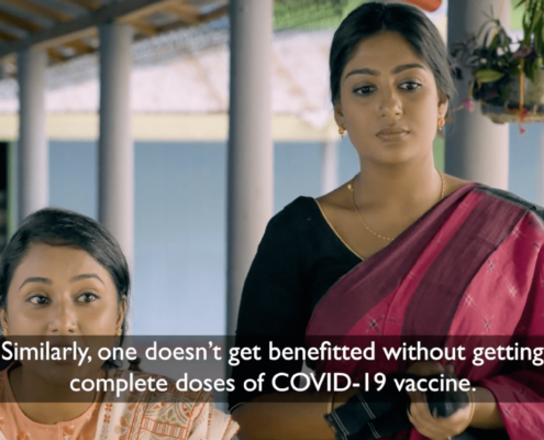 Two women from Bangladesh speaking. The text reads: "Similarly, one doesn't get benefitted without getting complete doses of COVID-19 vaccine"